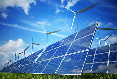 A field with wind turbines and solar panels